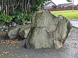 Large fractured stone with carvings