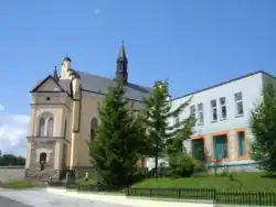 Main street in Bukowsko, Catholic Church and city bank.