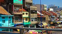A row of long-standing shophouses on Võ Văn Kiệt Boulevard, seen from Ông Lãnh Bridge