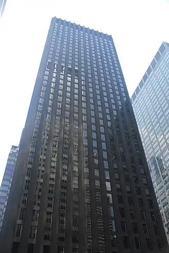 The CBS Building, a skyscraper with a glass-and-black-granite facade, as seen from ground level on a sunny day