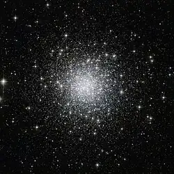 Thousands of white-ish dots scattered on a black background, strongly concentrated towards the center