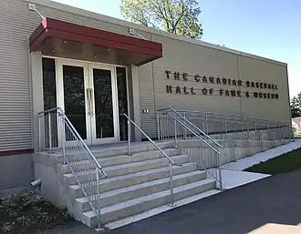 A long low building with baseball bat door handles, business name at right in red letters
