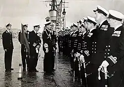 Captain R.T. White DSO** on board HMS Glory, standing behind Admiral Lord Mountbatten