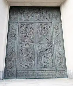 Church front door with bas-relief