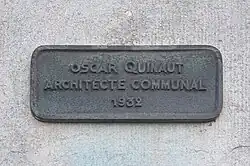 Plaque with the architect's name and date of construction.