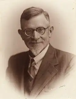 portrait photo with a caption showing the man's name