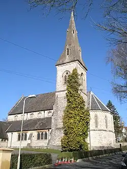 Christ Church, Winchester, Hampshire, 1861 by Ewan Christian, showing the south-east tower and broach spire and the polygonal chancel apse. The church has a striking clerestory with cinquefoil windows[122]