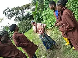 Four people speaking with a farmer in Nigeria
