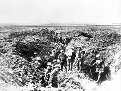 Soldiers in a ruined trench system the landscape is devoid of any flora or fauna