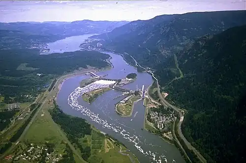 Aerial view of spillway flanked by powerhouses, Bonneville Lock (near right) and Lake