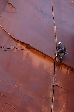 A traditional climber leading a crack climb in Indian Creek, Utah