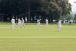 Colour photo showing a cricket ground