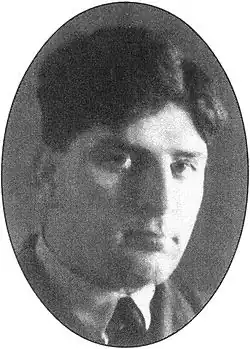 Portrait of a caucasian man in dark tie, light shirt, and dark jacket