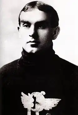 Black and white photo of a man aged 21 years, wearing a dark-coloured hockey sweater