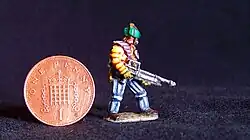 Miniature figure painted by Duncan Probert. The figure is slightly taller than an English penny and is in the style of a starship trouper on patrol.