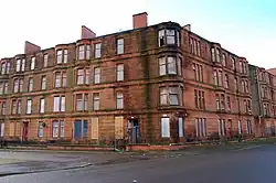 Victorian sandstone tenements in Ardenlea Street that were originally renovated as part of the GEAR (Glasgow Eastern Area Renewal) scheme in the late 1970s, but had their residents systematically rehoused, which led them to fall into a dilapidated state once more. They were totally demolished as part of the 2014 Commonwealth Games Athletes' Village masterplan by RMJM.
