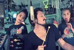 Malka Mikkelsen performing Depeche Mode's "Everything Counts" with their children, Korben and Milah, in 2011.