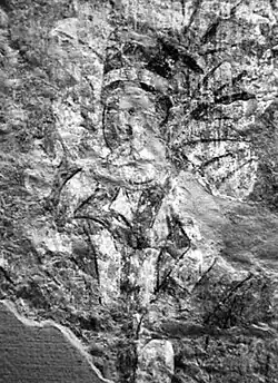 Man in white caftan coming out of a tree