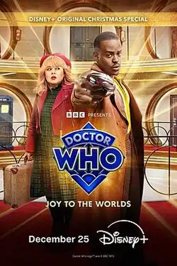 Two characters from the television series Doctor Who are in a hotel. The primary text reads "Doctor Who: Joy to the Worlds – December 25."