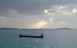 A man on a small boat on the ocean