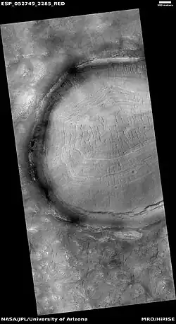 Crater with pits on floor, as seen by HiRISE under HiWish program When it formed, this crater had a bowl-like shape, now it is flat. As craters age, material moves in from the walls and from the sky. Much ice-coated dust accumulates. When ice disappears, pits are created.