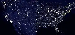 Nighttime satellite image of the contiguous United States showing light pollution in densely populated areas
