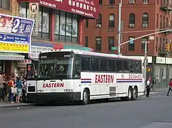 Passengers boarding a bus on a city street in warm weather