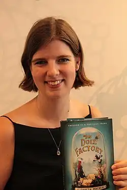 Elizabeth Macneal holding "The Doll Factory"