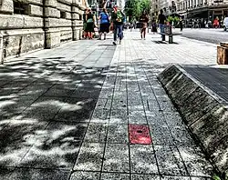 Red stone marking the place of the assassination of President Sadi Carnot on the Rue de la République in 1894