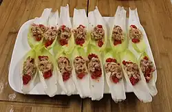 Belgian endive leaves stuffed with shrimp and served as an appetizer