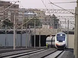 A high-speed train entering the station from the east.