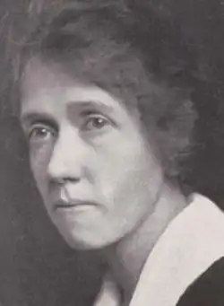 A yearbook photograph of a middle-aged white woman wearing a large white collar; she is not smiling