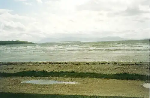 Looking south over a stormy Ettrick Bay. The island of Arran is visible in the distance