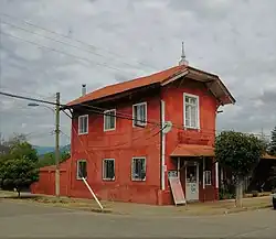 Derelict two-story building, formerly a train station