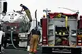 A water storage truck transferring water to a CBPR engine.
