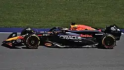 Max Verstappen driving the red, blue and yellow Red Bull RB20 car at the 2024 Austrian Grand Prix