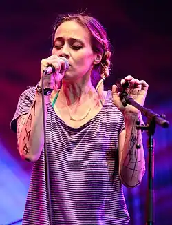 Fiona Apple singing with her eyes closed.