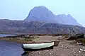 Fionn Loch and Suilven. The path by the River Kirkaig leads to the shore of the Fionn Loch, where boats wait for anglers. The distinctive bulk of Suilven dominates the view.
