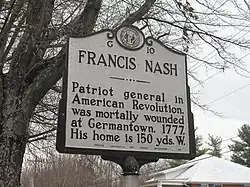 A Highway Historical Marker along a roadway detailing Nash's biography