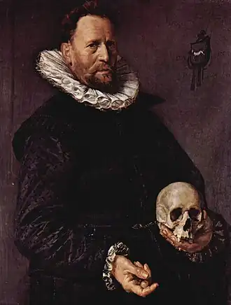 Portrait of a man holding a skull