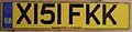 A pre-2001 UK number plate displaying the optional EU identification band.