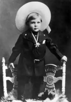 Photo of Gary Cooper dressed as a cowboy at the age of two