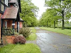The gatehouse and driveway of Stanford Hall