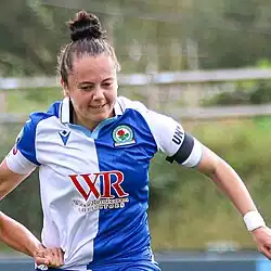 woman footballer, in white and blue of Blackburn