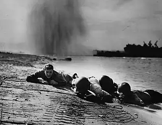 Hugging the Beach at Salerno (September 1943), Sargent's photograph of Coast Guardsmen flat on the sand under German bombardment during Operation Avalanche