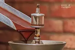 Fully ground cocoa exiting from a cocoa mill