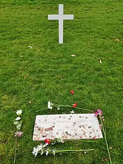Grave of Robert F. Kennedy. A cross with few flowers can be seen.