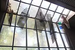 Suspended stained glass and perforated metal sculpture, 20 units by Virginia Gunter for Green Street, Boston MA for the MBTA