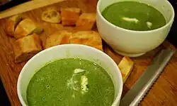 Green garlic and spinach soup, topped with crème fraîche