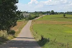 A paved road in the village of Grzybina leading to Lithuania